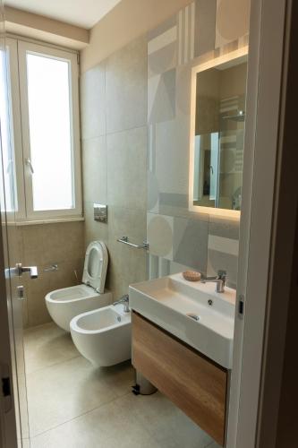 a bathroom with a toilet and a sink and a mirror at Freedom in SantʼAntonio Abate