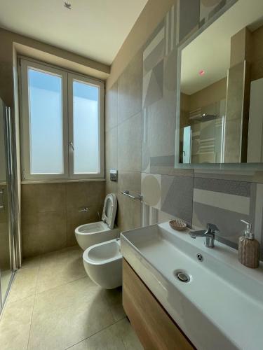 a bathroom with a toilet and a sink and a mirror at Freedom in SantʼAntonio Abate