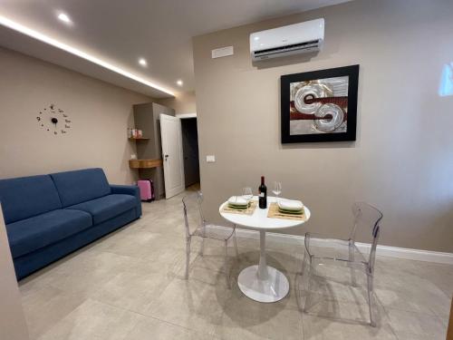 a living room with a table and a blue couch at Freedom in SantʼAntonio Abate