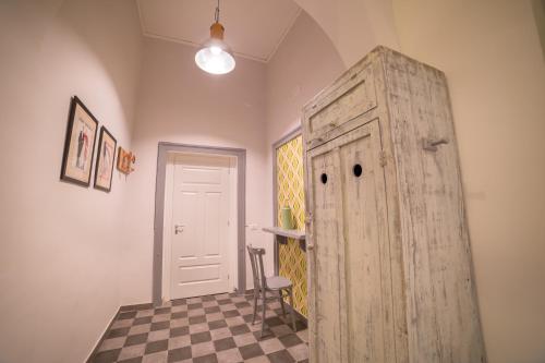 a room with an old wooden door and a chair at The Foria House by House In Naples in Naples