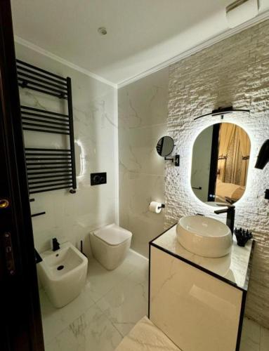 a bathroom with a sink and a toilet and a mirror at Barberini Dream in Rome