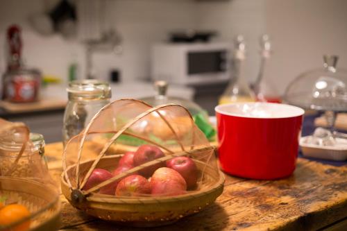 a bowl of fruit on a counter with a bowl of apples at The Foria House by House In Naples in Naples