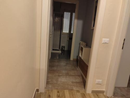 a hallway leading into a room with wood floors at San vito 9 in Agrigento