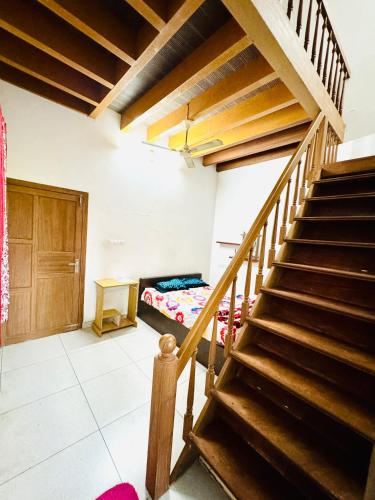 a room with a staircase and a bed in it at Thottungal Homestay in Ernakulam