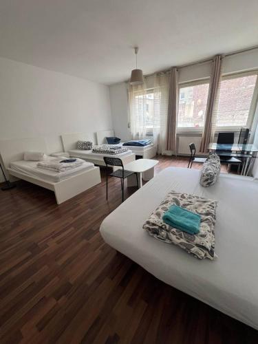 a large room with two beds and a couch at Big Apartments in Dortmund