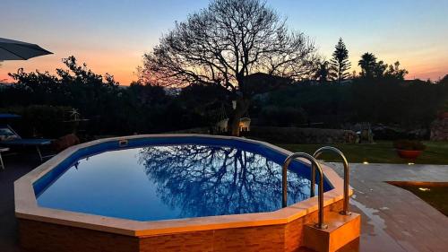 a large swimming pool with a reflection in the water at La Casa del Vagabondo in Belvedere