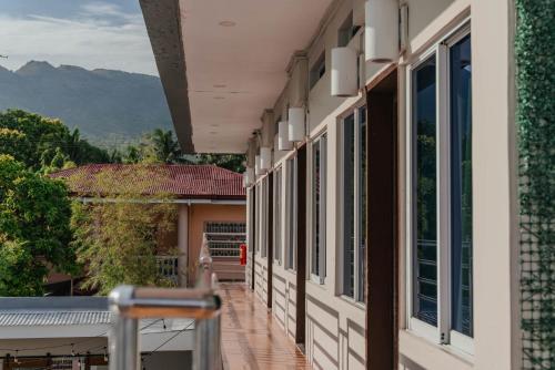 a balcony of a house with a view of the mountains at GT Seaside Inn in Oslob