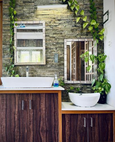a bathroom with a sink and a mirror at Thottungal Homestay in Ernakulam