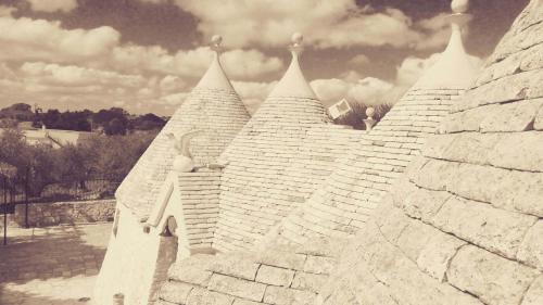 a black and white photo of a white castle at Trullo Sereno Angelo in Locorotondo