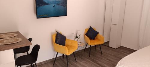 a bedroom with two chairs and a table and a bed at Apartman Luka in Trojica