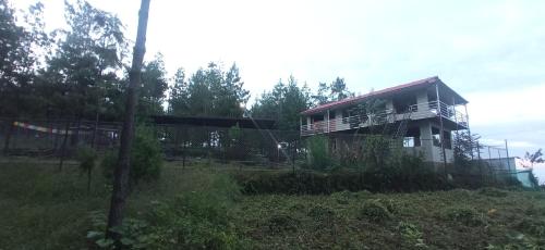 a house sitting on top of a field at Everest Home Stay Temal Kalimati Tower in Thapathali