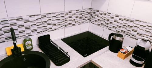a bathroom with a black sink and a counter top at Apartman Luka in Trojica