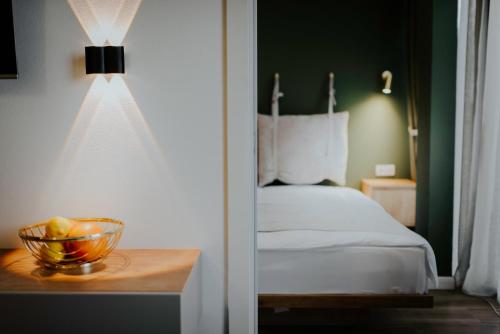 a bedroom with a bed and a bowl of fruit on a table at Luxury Inn Grand Residences in Tbilisi City