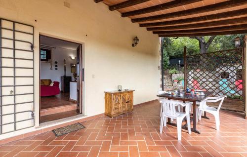 a patio with a table and chairs on a brick floor at Villa Marisa in Monteverdi Marittimo