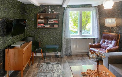a living room with a couch and a chair and a window at Three-Bedroom Holiday Home In Brakne Hoby in Bräkne-Hoby