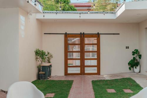 an open door of a building with grass at GT Seaside Inn in Oslob