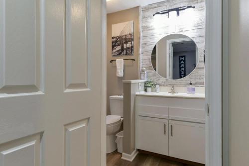 a bathroom with a sink and a toilet and a mirror at Sweet Clover - Indoor pool - Hot Tub in Branson