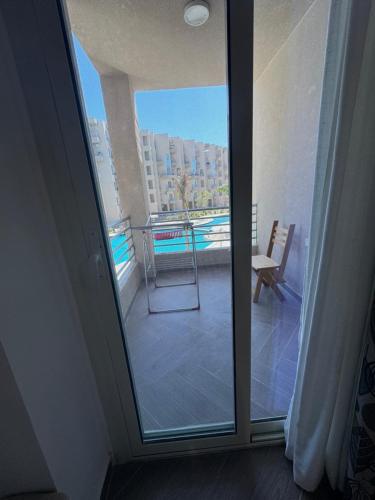 a door to a balcony with a view of a pool at Luxury Smart Home- Villa Duplex in Hurghada