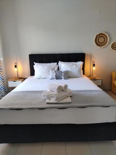 a bedroom with a bed with towels on it at Nini's House Superior Nydri - 100m from beach NYDRI TOWN CENTER in Nydri