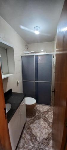 a small bathroom with a toilet and a sink at Residencial Vitor Studio in São José dos Pinhais