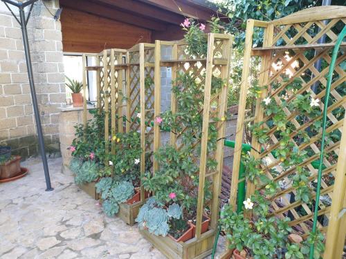 a wooden fence with flowers and plants in it at Guest House G & G in Castelnuovo di Porto