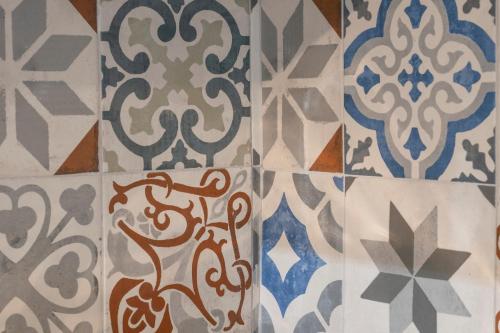 a group of different types of tiles on a wall at Casa Pina B&B in Spoltore