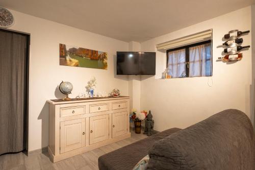 a bedroom with a bed and a tv on the wall at Casa Pina B&B in Spoltore