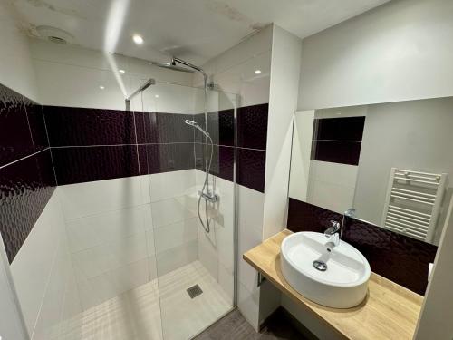 a white bathroom with a sink and a shower at Domaine des 5 Roses - Rose Rouge in La Guierche