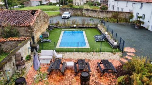 an aerial view of a backyard with a swimming pool at Domaine des 5 Roses - Rose Rouge in La Guierche