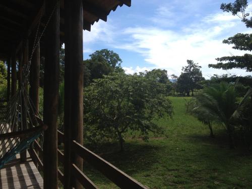 a porch of a house with a view of a field at Villa Pura Vida in Sándalo
