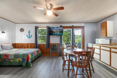 a bedroom with a bed and a table and chairs at Artilla Cove Cabin 4 - Lake views - Outdoor pool in Branson