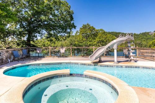 a swimming pool with a slide in the middle at Artilla Cove Cabin 4 - Lake views - Outdoor pool in Branson