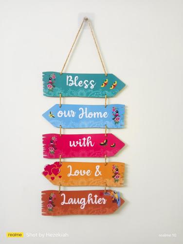 a wooden sign with the words bless our home with love and laughter at Jas Homestay Madurai in Tirupparangunram