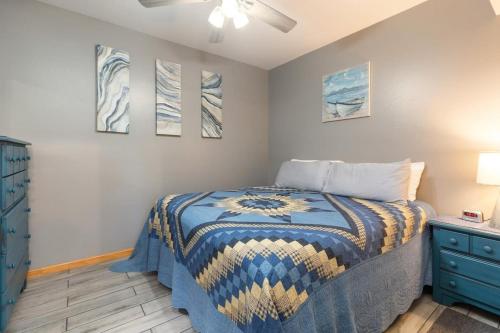 a bedroom with a bed and a blue dresser at Artilla Cove Cabin 8- Lakeview- BBQ Area- Pool in Branson