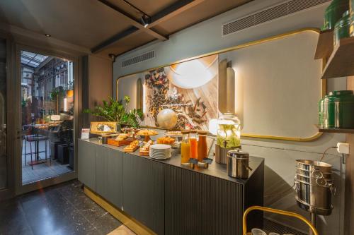 a buffet line with food in a restaurant at Duomo Smart Suites in Milan