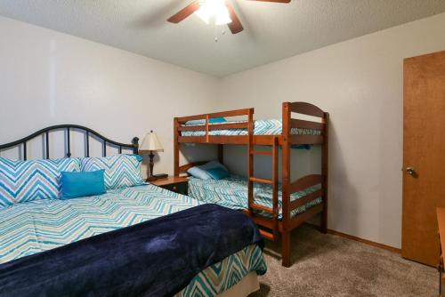a bedroom with a bed and bunk beds in it at Divine 9 Condo -Fishing Lake & Hiking Trails in Reeds Spring