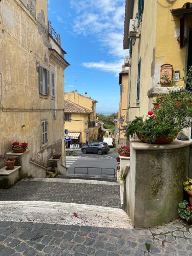 an alley with a car driving down a street at Casa Antonella in Castel Gandolfo