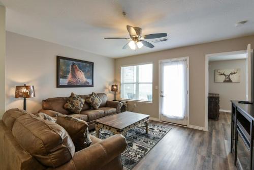 a living room with a couch and a table at Mystic Cove Condo - Pool - Perfect location in Branson