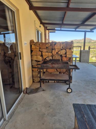 a pile of fire wood on a cart in front of a building at Jakkalswater guest farm in Nababeep