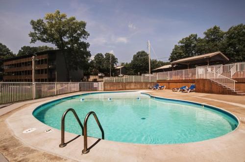 a large swimming pool with blue water in a building at Westcreek Ranch - No Stairs in Branson West
