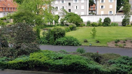 une vue aérienne sur un parc planté d'arbres et de buissons dans l'établissement Colmar TOP, à Colmar