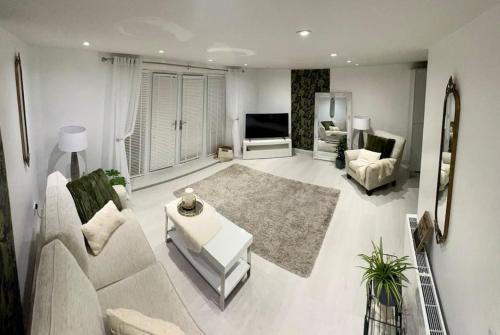 a living room with a couch and a tv at Marina Apartment by the Sea in Hartlepool