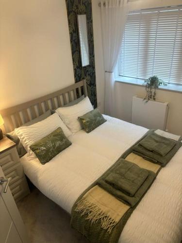 a bedroom with a large bed with pillows and a window at Marina Apartment by the Sea in Hartlepool