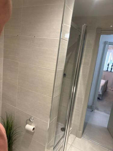 a shower with a glass door in a bathroom at Marina Apartment by the Sea in Hartlepool