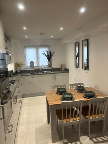 a kitchen with a table with chairs and a sink at Marina Apartment by the Sea in Hartlepool