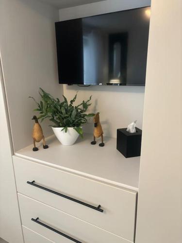 a white dresser with two figurines on top of it at Marina Apartment by the Sea in Hartlepool