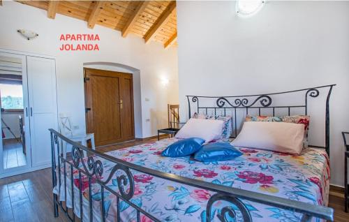a bedroom with a bed with blue pillows at Apartma Jolanda in Šmarje