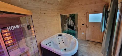 a bathroom with a tub in the middle of a room at Plitvice Inn in Jezerce