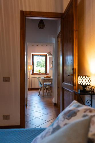 a bedroom with a bed and a dining room at Agriturismo Casale le Crete in Acquapendente