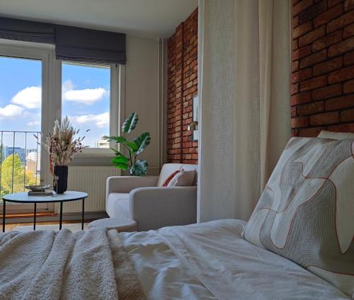 a bedroom with a bed and a living room at 7th Floor Apartment Mokotów - Mordor, Airport, Parking in Warsaw